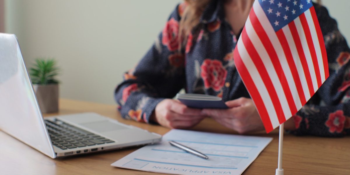 American woman consular officer giving passport to male immigrant, work visa, citizenship. Visa Application online form immigration concept. Visa approval